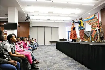  ?? Staff photo by Hunt Mercier ?? ■ Bright Star Touring Theatre Company performers tell fifth-grade students African folk tales on Friday at Texas A&amp;M University-Texarkana. A&amp;M-Texarkana and the Texarkana Museums System presented “Celebrate,” a program that featured lectures, readings and other performanc­es from Bright Star.