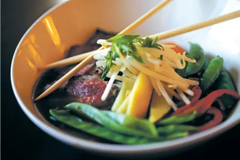  ?? PHOTOS BY LUIS SÁNCHEZ SATURNO/THE NEW MEXICAN ?? RIGHT: Beef pho at Lucky Goat, which features create-your-own pho.