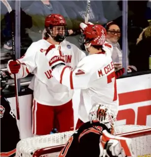  ?? ANDY CLAYTON-KING/ASSOCIATED PRESS ?? BU freshman Macklin Celebrini (right) celebrates a goal by classmate Jack Harvey in Thursday’s 6-3 victory over RIT in Sioux Falls, S.D.