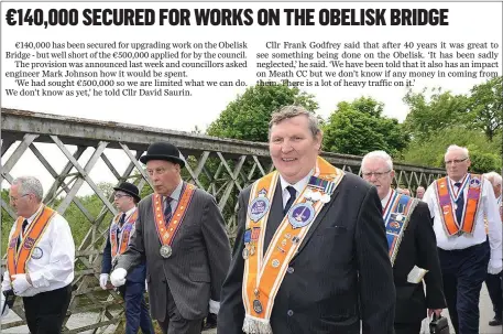 ??  ?? Orangemen walking over the historic Obelisk Bridge , the route across the Boyne that’s set for a €140,000 investment.