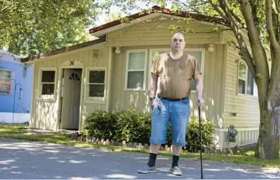  ?? LAUREN PETRACCA/AP ?? Jeremy Ward, who receives disability payments, was fined $10 for using a leaf blower near his New York mobile home.