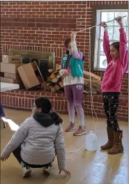  ?? RENEE BORCAS — THE NEWS-HERALD ?? Girl Scouts get hands-on experience learning how simple and compound machines work at a Badge-in-a-Day event hosted by the Geauga County Public Library.