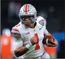  ?? KEVIN C. COX/GETTY IMAGES ?? Ohio State's Justin Fields runs with the ball against Clemson at the Allstate Sugar Bowl on Jan. 1 in New Orleans.
