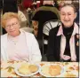  ??  ?? Gloria Prout and Bobbie Kontra of Pottstown enjoy pierogies and potato pancakes at Holy Trinity Orthodox Church.