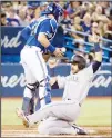 ??  ?? Seattle Mariners’ Austin Nola (right), is safe at home plate as Toronto Blue Jays catcher Reese McGuire bobbles the ball in the second inning of a baseball game
in Toronto on Aug 17. (AP)