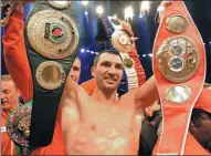  ?? AP FILE ?? Wladimir Klitschko celebrates with his belts after winning a 2011 heavyweigh­t title unificatio­n bout against David Haye in Hamburg, Germany.