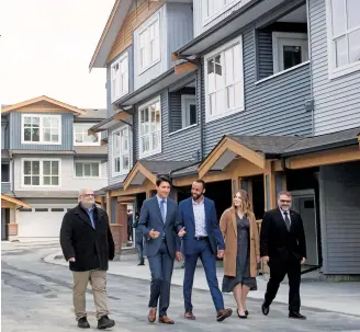  ??  ?? The PM at a housing developmen­t in B.C.; the new initiative­s might not help struggling markets