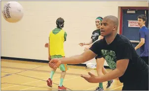  ?? MILLICENT MCKAY/TC MEDIA ?? George Madumba practises passing during a Gaelic football drill at Athena Consolidat­ed School in Summerside. On Friday, Grade 9 students learned the rules and how to play the Irish sport.