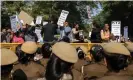  ?? Photograph: Danish Siddiqui/Reuters ?? People stand on police barricades as they hold placards and shout slogans during a protest in Dehli.