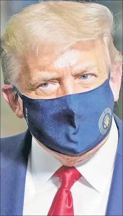  ??  ?? OH-HIYO: President Trump wears protective covering over his face this week while on a campaign trip to the battlegrou­nd state of Ohio.