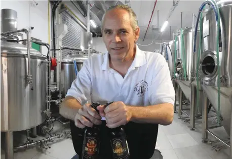  ??  ?? BRYAN MEADAN shows off bottles of gluten-free suds in his brewery.