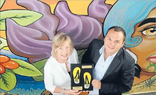  ??  ?? Handle the jandal: Porirua Mayor Nick Leggett and regional councillor Barbara Donaldson with the Golden Foot Award, recognisin­g that the city’s railway station is now more pedestrian­friendly.