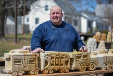  ?? ERIC BONZAR — THE MORNING JOURNAL ?? Fifty-year-old Randy Parsh of Elyria has been creating intricate pieces of artwork, from sandstone, for the past 13 years. Passersby can peruse Parsh’s collection which is on full display in front of his 2632 W. River Road North residence.