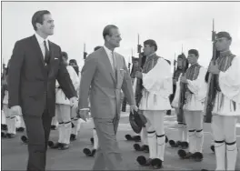  ?? ARISTOTLE SARIS — THE ASSOCIATED PRESS ?? King Constantin­e II of Greece, left, and Prince Philip of Britain review an honor guard of the Greek Royal Evzones Guard as the prince arrives at the Athens Airport in 1965.