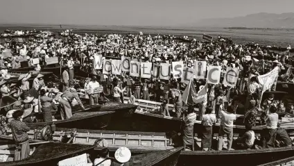  ?? Aung Ko San / Associated Press ?? Members of the ethnic Intha community display placards during a protest against the military coup Thursday in Inle Lake, Myanmar. Large crowds demonstrat­ing against the military takeover in Myanmar have continued to defy a ban on protests.