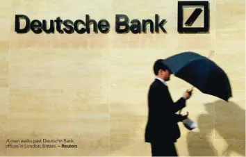  ?? — Reuters ?? A man walks past Deutsche Bank offices in London, Britain.