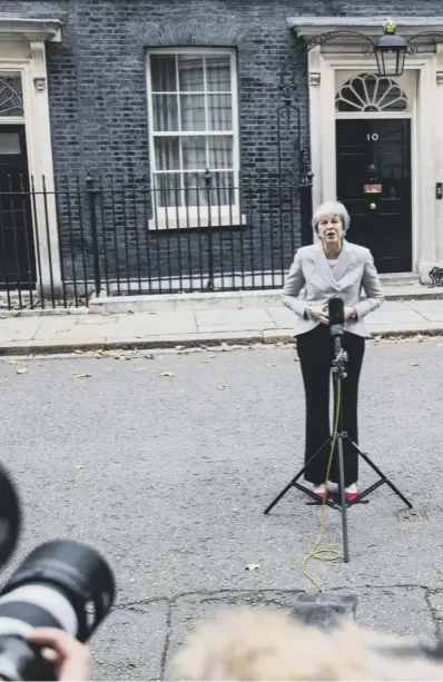  ??  ?? 0 Prime Minister Theresa May stands outside Number 10 to announce the agreement with the EU. She said the draft text ‘honours the vote of the British people’