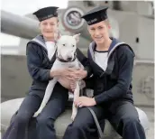  ?? ?? Two ratings pose with Bill, the ship’s mascot, on the upperdeck of Hood, 1940