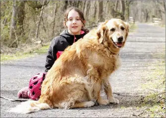  ?? PHOTO COURTESY OF MARIE HAIGH – FOR MEDIANEWS GROUP ?? Brooke Haigh, 9, poses for a photo with her dog Clover while on the Schuylkill River Trail in Pottstown.