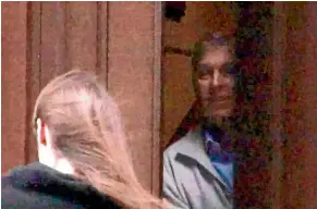  ??  ?? The Duke of York peers from a door in Jeffrey Epstein’s New York mansion in a screengrab from a video secured by The Mail on Sunday.