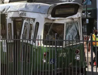  ?? AP FILE (ABOVE); PHOTO COURTESY OF ELIZABETH BOYCE-JACINO (LEFT) ?? WHAM: A damaged Green Line train is seen after crashing into another trolley July 30 on Commonweal­th Avenue. At left, the aftermath of Tuesday’s derailment.