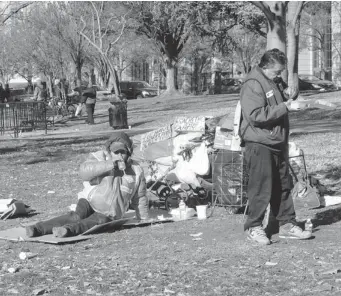  ?? PHOTOS: WILLIAM MARSDEN/ POSTMEDIA NEWS ?? Washington’s homeless mark Thanksgivi­ng on Thursday with turkey dinners distribute­d in downtown Franklin Square park. On any given night, close to 7,000 people are counted as homeless in the U.S. capital.