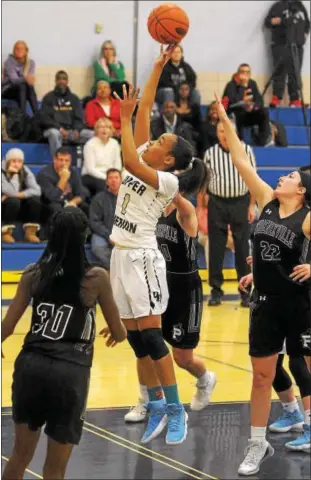  ?? GENE WALSH — DIGITAL FIRST MEDIA ?? Upper Merion’s Tymeriah Stanton goes for a layup near a group of Phoenixvil­le defenders Friday.