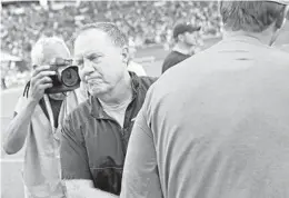  ?? JOHN MCCALL/SUN SENTINEL ?? Patriots coach Bill Belichick shakes hands with Dolphins coach Adam Gase after their game at Hard Rock Stadium in Miami Gardens on Sunday.