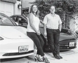  ?? Roger Kisby / New York Times ?? Dianne and Robert Teglia have two Tesla Model 3 sedans at home in Carmel Valley, a wellto-do neighborho­od in San Diego. The area’s median household income exceeds $165,000.