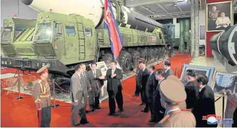  ?? REUTERS ?? North Korea’s leader Kim Jong-un speaks to officials next to military weapons and vehicles on display, including the country’s interconti­nental ballistic missiles, at the Defence Developmen­t Exhibition, in Pyongyang, North Korea, on Tuesday.
