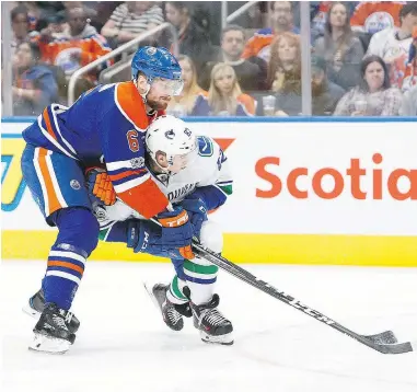  ?? — GETTY IMAGES FILES ?? Nikolay Goldobin gets tied up by Edmonton’s Adam Larsson in a game earlier this year. With more grit, the skilled young winger could be part of the answer to Vancouver’s scoring troubles next season.