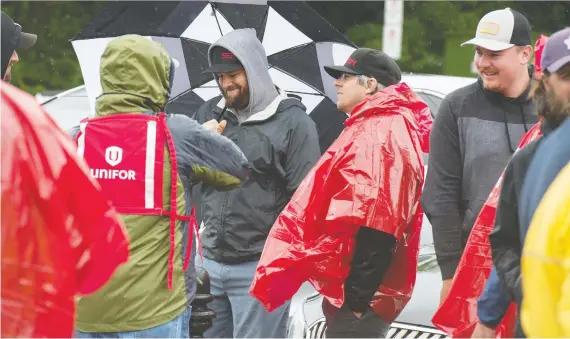  ?? BRANDON HARDER ?? Unifor pickets chat in front of the Saskatchew­an Legislativ­e Building in Regina on Thursday after hearing that a tentative agreement had been reached with the Co-op Refinery Complex to end the bitter lockout that began last December. The union contended the company was out to break the union.