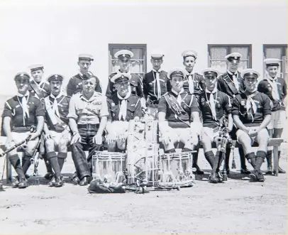  ??  ?? Top: Pipe Major Roy with Eisenhower in 1952; and, above, with Sea Scouts in Hong Kong who he took for bagpipe practice during his time there.