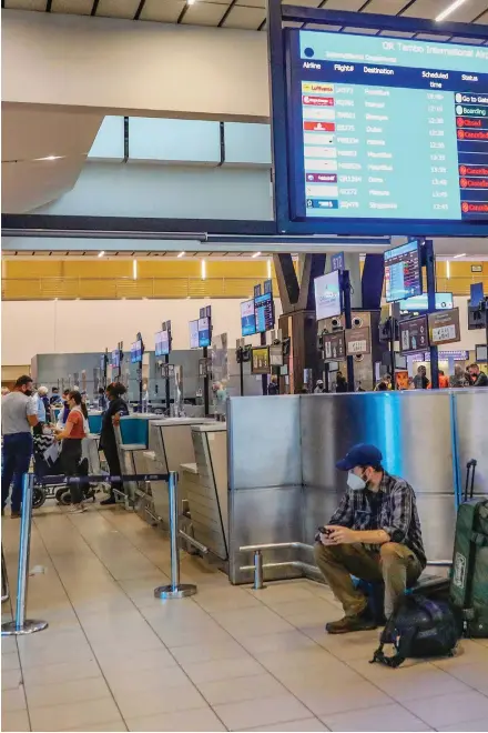  ?? ?? An electronic flight notice board displays cancelled flights at OR Tambo Internatio­nal Airport in Johannesbu­rg on November 27, 2021, after several countries banned flights from South Africa following the discovery of the new Covid-19 variant Omicron