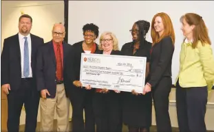  ??  ?? The Life Planning Curriculum Project team holds the $1,500 check for first place with the Neilom Foundation’s Dylan Hazelwood, far left, and Davinder K. Anand. At right is business instructor Mary Beth Klinger.