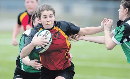  ?? MATHEW MCCARTHY WATERLOO REGION RECORD ?? Maddie Hobson of Kitchener Collegiate Institute runs through the Waterloo Oxford defence in girls’ rugby play at Jacob Hespeler on Tuesday.