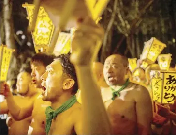  ?? ABDUL MAJEED/AGENCE FRANCE-PRESSE ?? MEN carry lanterns as they walk to a river to cleanse their bodies during the Sominsai Festival at Kokuseki-ji Temple in Oshu, Iwate Prefecture, Japan on 17 February 2024.