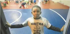  ?? BRIAN KRISTA/BALTIMORE SUN MEDIA GROUP ?? Nine-year-old Amondre Wooden takes a break while practicing with the Lansdowne Gators youth wrestling team in 2014.