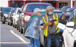  ?? CHRIS CARLSON/AP ?? A customer gets help pumping gas Tuesday at a busy Costco in Charlotte, North Carolina. Colonial Pipeline delivers about 45% of the fuel consumed on the East Coast. A large part of the pipeline resumed operations manually late Monday.