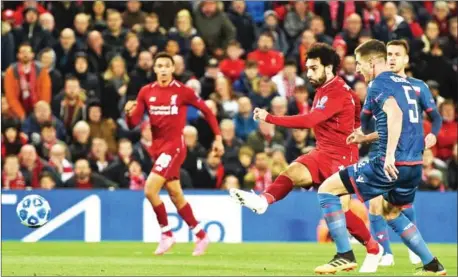  ?? OLI SCARFF/AFP ?? Liverpool midfielder Mohamed Salah scores his side’s second goal in their Champions League Group C match with Red Star Belgrade at Anfield in Liverpool, northwest England on Wednesday.