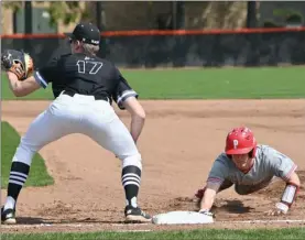  ?? PILOT PHOTO/KATHY HALL ?? Cam Shively dives back safely at first during Plymouth’s game to Laporte.