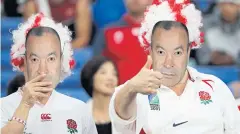  ?? AP ?? Fans wearing the face masks of England coach Eddie Jones.