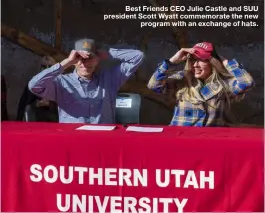  ??  ?? Best Friends CEO Julie Castle and SUU president Scott Wyatt commemorat­e the new
program with an exchange of hats.