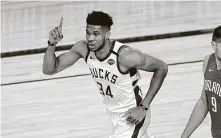  ?? Ashley Landis / Associated Press ?? The Bucks’ Giannis Antetokoun­mpo joined Rockets legend Hakeem Olajuwon and Michael Jordan as the only players named MVP and Defensive Player of the Year in the same season.