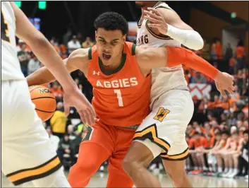  ?? NATHAN WRIGHT — LOVELAND REPORTER-HERALD ?? Colorado State’s John Tonje fights through the Wyoming defense on his way to the basket in their game Friday at Moby Arena.