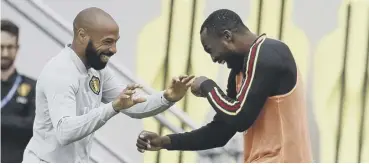  ?? PICTURE: AP ?? 0 Thierry Henry, left, and Romelu Lukaku share a joke in training.