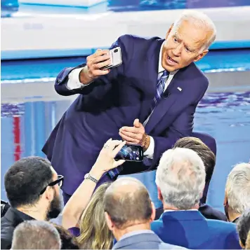  ??  ?? Joe Biden takes a selfie during the first Democratic primary debate in Miami, Florida, where his performanc­e was seen as lacklustre