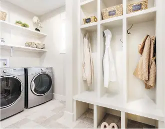  ??  ?? This mud room in the Bowen show home by Stepper Homes includes laundry machines.