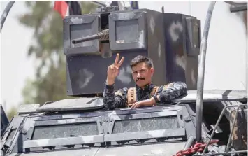  ?? — AFP ?? A member of the Iraqi federal police flashes the victory sign during the advance through the Old City on Monday.