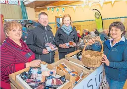  ?? Pictures: Steve MacDougall. ?? Top: Visitors check out the stalls at Coupar Angus Town Hall during Strathmore Tattie Day; middle: John Marshall at his model potato farm with, from left, Tom Dijkstra-Downie, 4, Mia Dijkstra-Downie, 7, and Eilidh Wilson, 6; and, above, from left, Susan Duncan of Blairgowri­e and Rattray Developmen­t Trust’s HEAT project, John and Rachael Penny of Simply Herdwick and Debbie McGowan from Incheoch Farm.